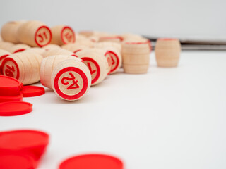 Board game bingo. Wooden barrels with lotto numbers, playing cards for the game. Close-up.