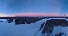 Panoramic Aerial View Of Beautiful Pink Clouds During Sunrise In Winter In Soukolojärvi, Sweden.