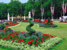 Decorative Flower Display In Memorial Garden Across The Street From Buckingham Palace In London, England, With Canada Gate And Green Park In The Background
