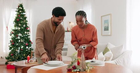 Poster - Couple, christmas and table while setting plate, dinner or lunch in living room for party, event or celebration. Black woman, man and festive in home for helping, smile and happiness in holiday