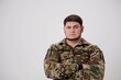 © Oleksandra - portrait of male in camouflage coat on gray background Studio shot of young bearded ukrainian man Young hispanic man