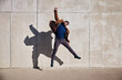 © baranq - Victory concept. Joyful man jumping against concrete wall celebrating success