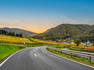 Wall Mural - Winding Road through Bruttig-Fankel village and steep vineyards during a beautiful autumn day in Cochem-Zell, Germany