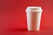 © diego - Plastic cup for hot drinks with a lid on a red background
