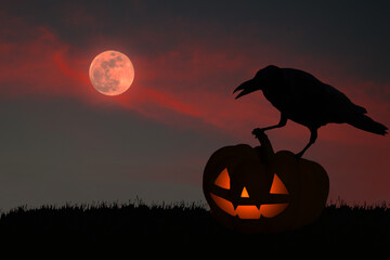 Wall Mural - Silhouette of a crow standing on a yellow pumpkin carved as a Halloween devil face in a red full moon sky setting.