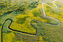 Top Down View On Exotic Winding River In Green Meadows. Ukraine, Europe.