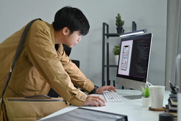 Wall Mural - Man UX graphic designer working for mobile application software design project at workstation