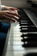 Cropped Hands Of Pianist Practicing Piano At Home