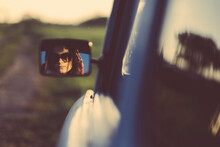 Woman Wearing Sunglasses Reflecting On Side-view Mirror During Sunset