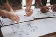 © kamiphotos - Architects and engineers are working together to edit the draft house plan that was designed after it was presented to the client and partially revised the design. Interior design and decoration ideas