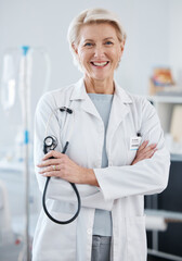 Canvas Print - Portrait, woman and doctor with arms crossed, stethoscope and happiness in hospital, clinic and surgery. Mature female medical worker smile for healthcare services, cardiology wellness and experience