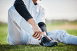 Baseball player, shoes and ankle pain, man with sport injury and emergency, first aid and need medical care outdoor. Accident, muscle tension and inflammation with male on sports field and fitness