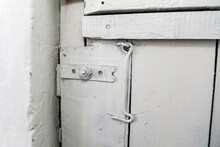 Old Wooden Door Painted White With Latch Instead Of A Lock.