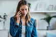 © nenetus - Beautiful young woman talking on the phone at home.