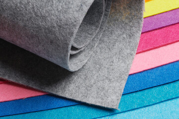 Multi-colored soft felt textile material, colorful patchwork texture fabric close-up