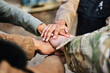 © M Einero/peopleimages.com - Mission, paintball team or hands in huddle for goals, hope or soldier training on war battlefield. Friends, collaboration or army people with support in partnership or military group solidarity
