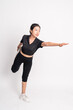 © Odua Images - woman standing doing leg stretching with balance on isolated background