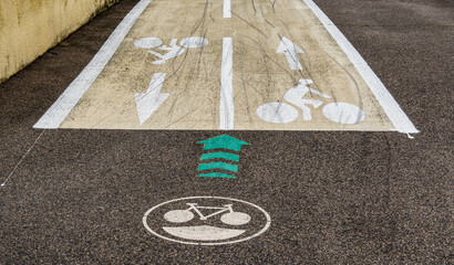 a two way, dedicated cycle way has created and is shown by clear directional usage signage - cyclist