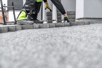 Wall Mural - laying interlocking pavers during the construction of sidewalks and roads