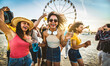 © Davide Angelini - Multiracial group of friends having fun dancing at sunset beach party - Happy young people enjoying music festival on weekend vacation - Life style concept with guys and girls enjoying summer vacation