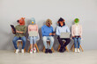 © Studio Romantic - Funny people with animal faces using computers while waiting for business appointment or job interview. Young employees or applicants in silly masks sitting in line and working on laptops and tablets