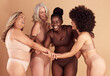 © David L/peopleimages.com - Beauty, diversity and group of women in lingerie in studio isolated on brown background. Underwear, friends and body positive females, self love and holding hands for empowerment, laughing or smiling