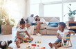 © David L/peopleimages.com - Tired parents on couch, children and playing with toys on weekend to relax, for bonding and sleepy in lounge. Family, mother and father with brother, sister and play educational games and exhausted.