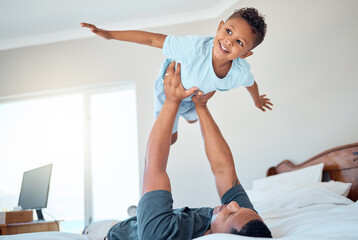 Wall Mural - Father lifting kid in air in the bedroom having fun, playing and enjoying morning together. Bonding, love and dad holding young child in bed to pretend to fly for quality time and relax with family