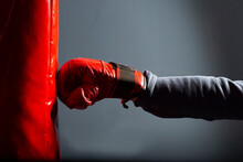 A Red Glove And A Red Punching Bag