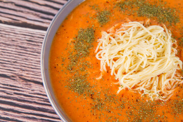 Sticker - Tomato soup with noodles on a wooden background