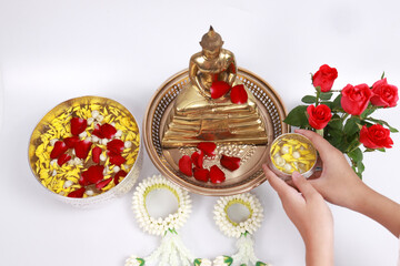 Sprinkle water onto a Buddha image, Asia culture to respect Buddha , Sonkran festival ,Buddhist Holy Day or Buddhist Sabbath Day