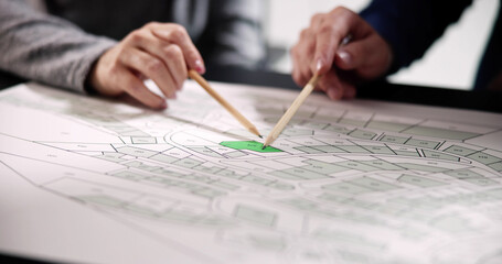 Poster - Human Hand Holding Pencil Over Paper Cadastre
