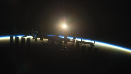 Wall Mural - international space station iss floating in orbit above planet earth in outer space. sunrise or suns