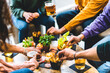 © Nicolas Micolani - Group of happy friends eating food and drinking beer  at brewery pub restaurant- Young people enjoying happy hour with appetizer gourmet at bar table- Life Style Dining and   Beverage concept