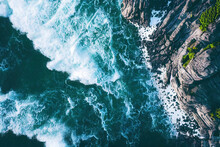 Spectacular Drone Photo, Top View Of Seascape Ocean Wave Crashing Rocky Cliff With Sunset At The Horizon As Background. Beautiful Coastal Scenic Landscape With Turquoise Water Beating Rocky Boulder.