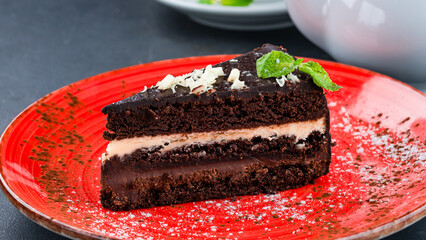 Canvas Print - A piece of chocolate cake with cream and mint.