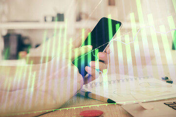 Poster - Double exposure of man's hands holding and using a digital device and forex graph drawing. Financial market concept.
