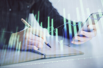Poster - Double exposure of forex graph sketch hologram and woman holding and using a mobile device. Stock market concept.