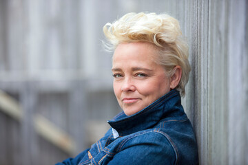 Outdoor portrait of attractive mature blond woman.