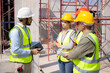 © N_studio - Team group of contractor and architect with foreman explaining about scheme building site for planning project to worker and looking blueprint, construction site, development and structure.