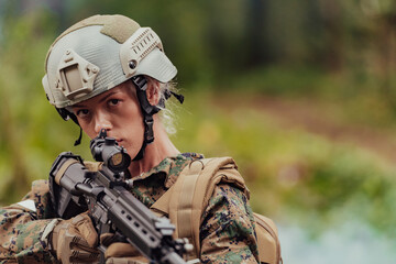 Wall Mural - Woman soldier ready for battle wearing protective military gear and weapon