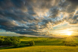 Fototapeta  - Sunset over a pasture filled with cattle