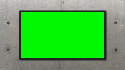 Picture frame on a green screen placed on a concrete wall