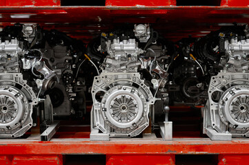 Car internal combustion engines stand on racks in warehouse