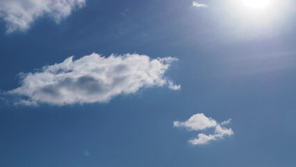 Wall Mural - a pan from the sky to a green field. bright blue sky with sun and a plane flies past.