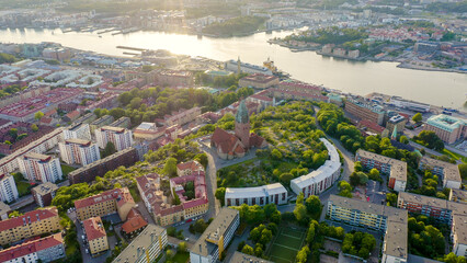 Wall Mural - Gothenburg, Sweden - June 25, 2019: StenaLine ferry passes along the river. Panorama of the city and the river Goeta Elv, From Drone