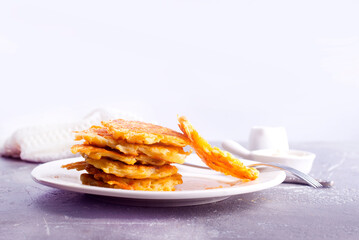 Wall Mural - Potato pancakes on white plate on a table