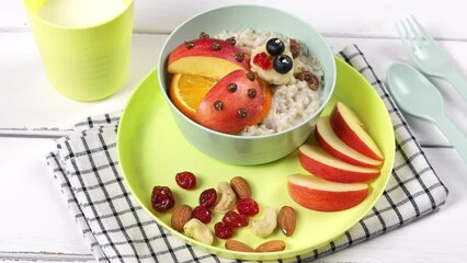 Wall Mural - Creative food for kids. Oatmeal with fruits in the form of a ladybug in a beautiful colorful dish. Healthy and fun food.