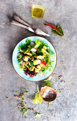 Poster - Avocado salad with cucumber and other vegetables in a blue vintage bowl