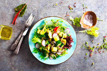 Poster - Avocado salad with cucumber and other vegetables in a blue vintage bowl